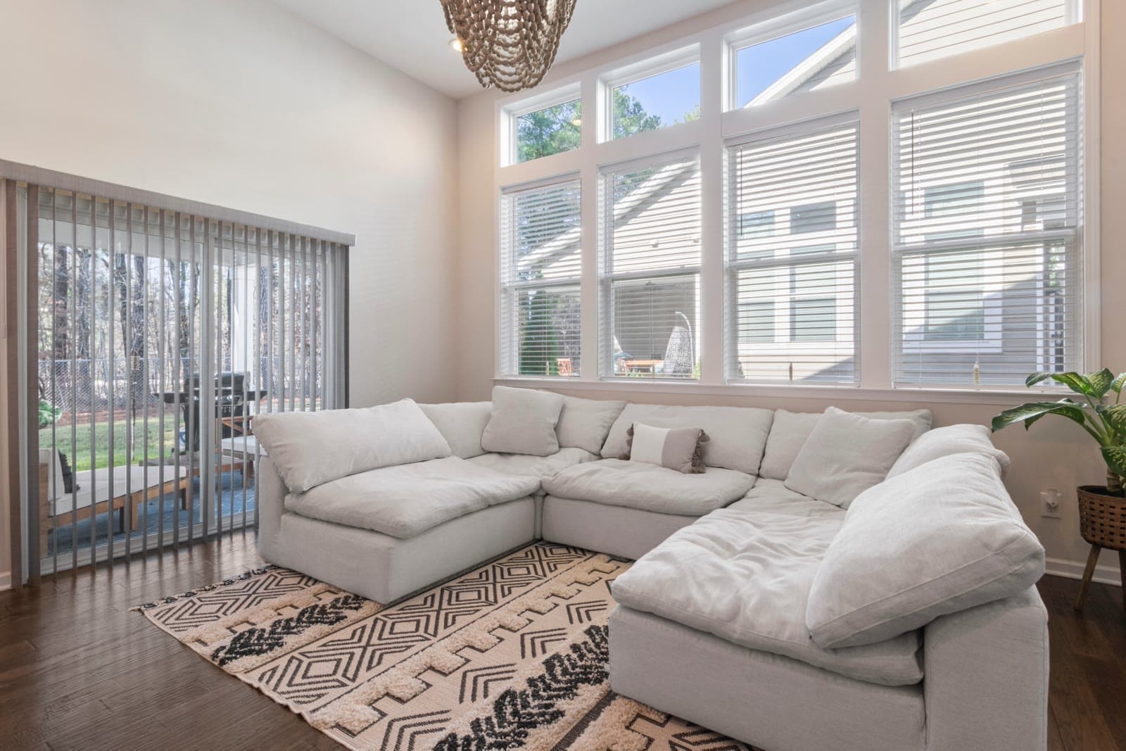 Bright, sunlit living room with a cozy sofa and large windows