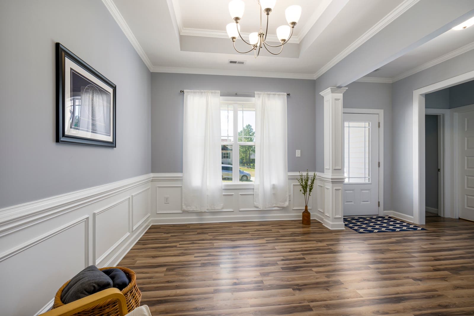 Bright, empty traditional-style room with dark hardwood floors, ready for its next chapter